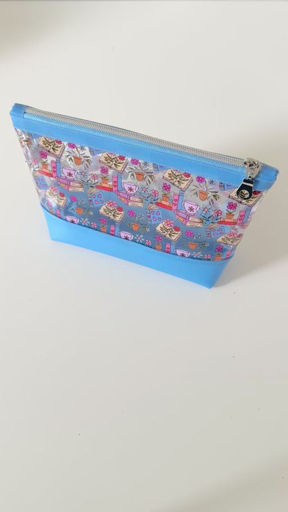 clear makeup bag with floral and book design