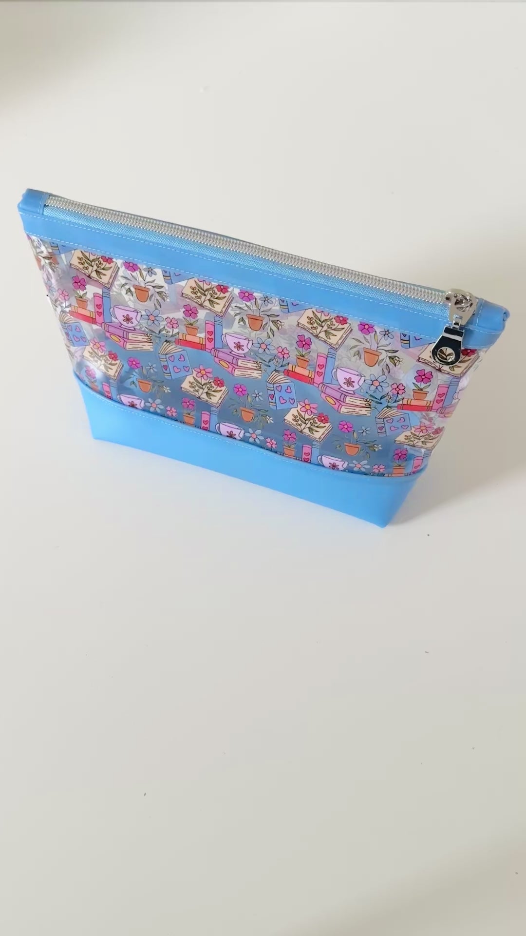 clear makeup bag with floral and book design