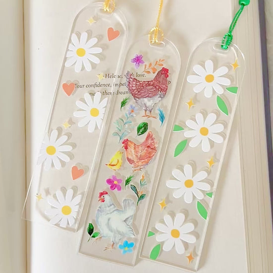 flower and chicken bookmarks on an open book