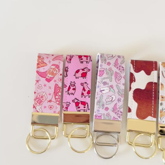 Western highland cow print and cowgirl pattern keychains made from vegan leather 
