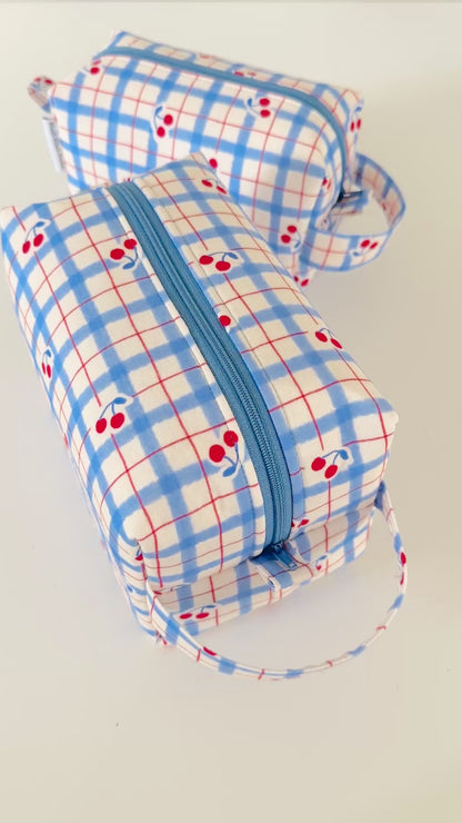 Set of 2 fabric pouches with blue plaid pattern and red cherries on a light gray background.