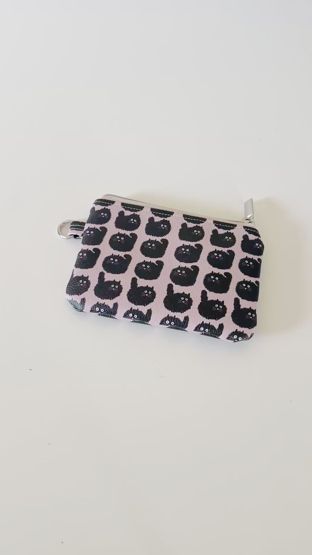 coin purse with a black cat pattern on a light background