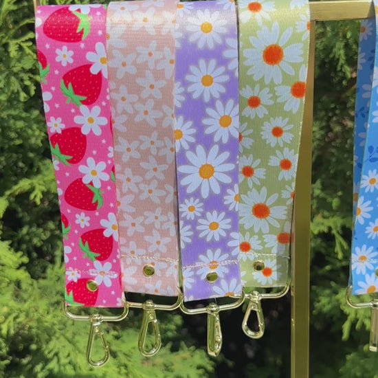 Set of six floral patterned keychains wristlet on a white background