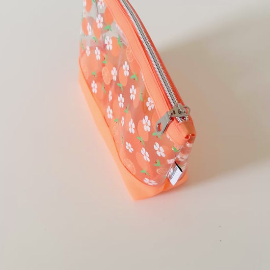 Clear pouch with white floral pattern on a light gray background