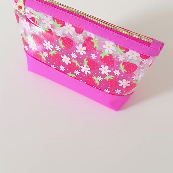clear makeup bag with a pink strawberry pattern
