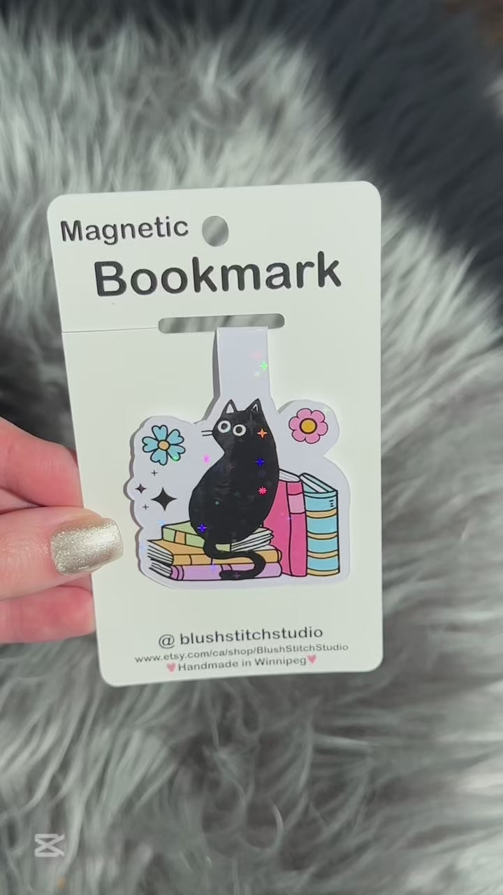 Magnetic bookmark with a black cat design on a gray textured background